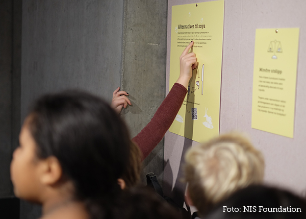 Students read posters in the exhibition